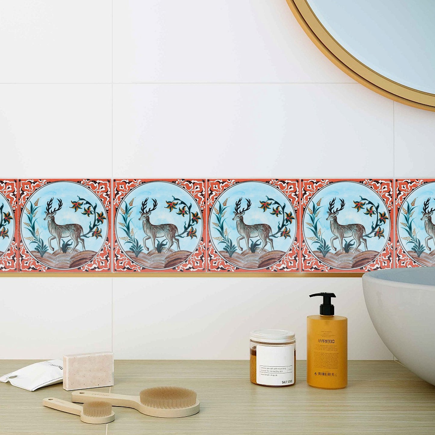 Decorative ceramic tiles with deer design on a bathroom wall.