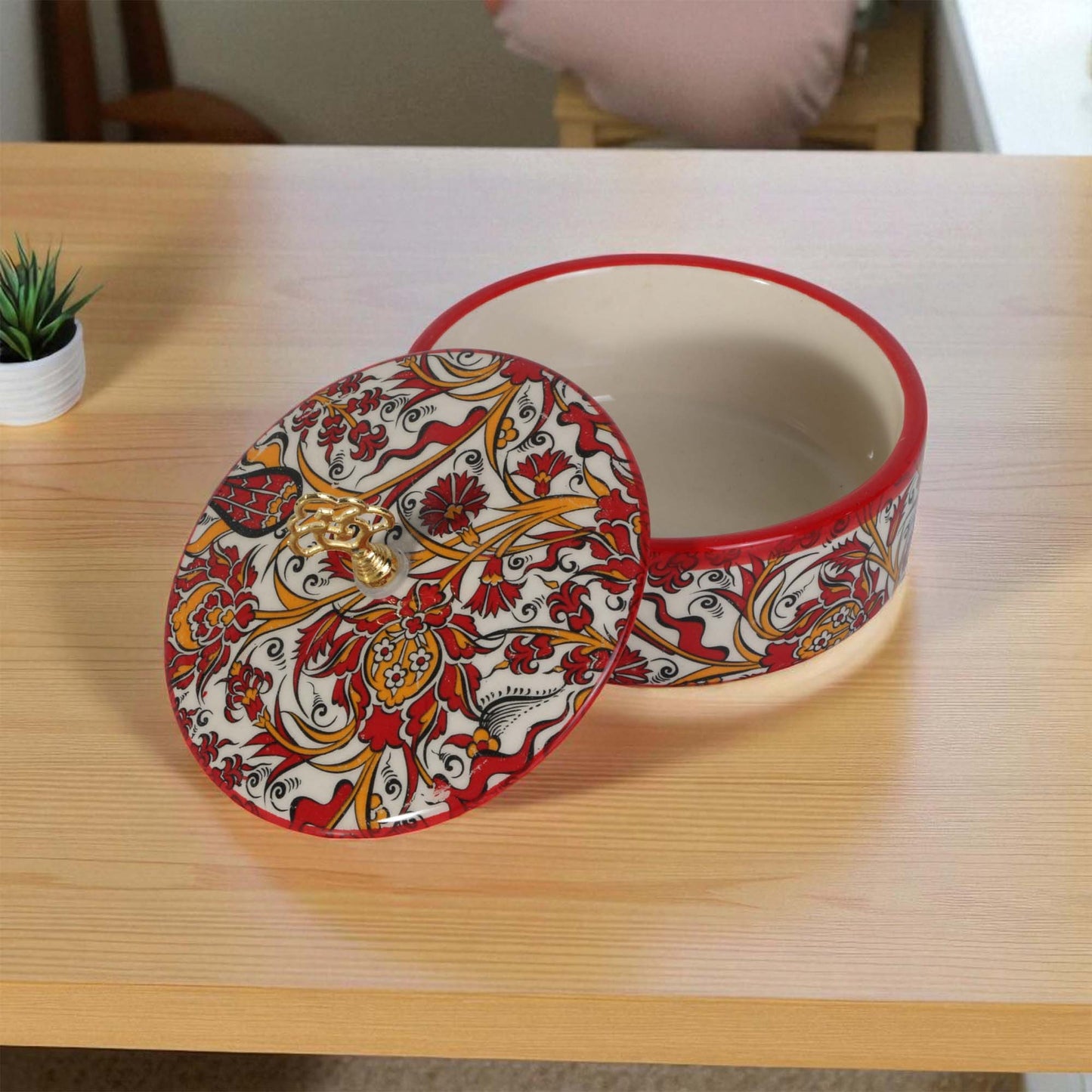 Decorative ceramic sugar bowl with a lid on a wooden table