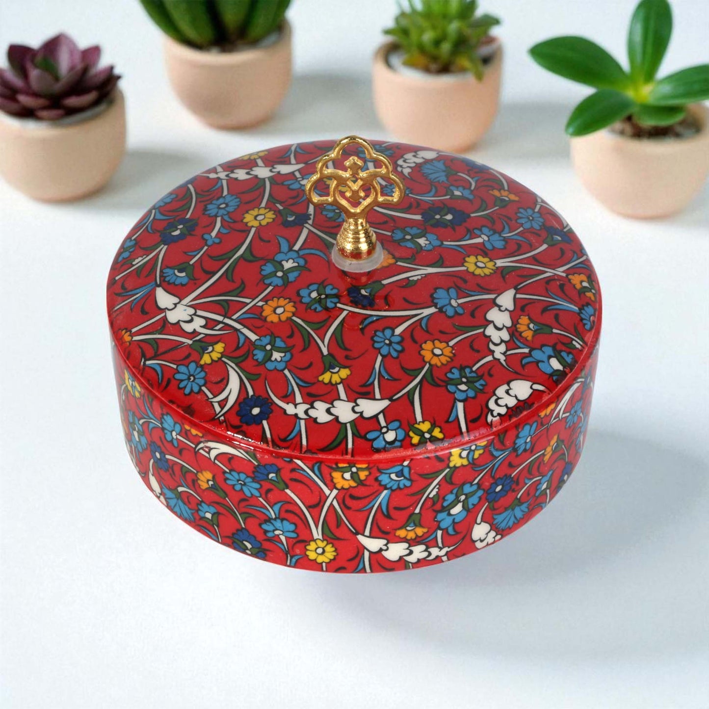 Decorative sugar bowl with floral pattern on a white background