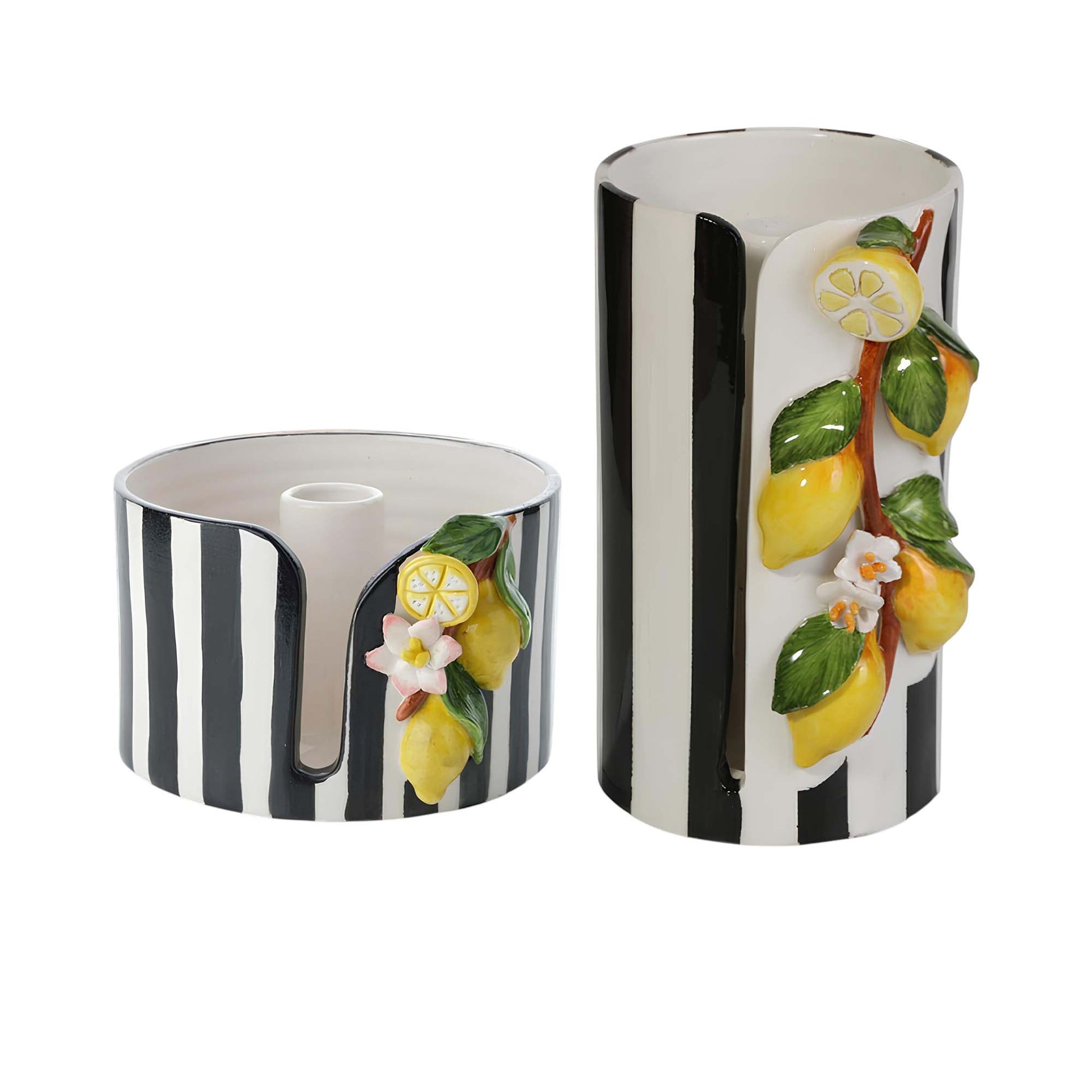 Two cylindrical ceramic paper towel holders with black and white striped design and lemon and flower decorations on a white background.