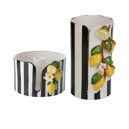 Two cylindrical ceramic paper towel holders with black and white striped design and lemon and flower decorations on a white background.