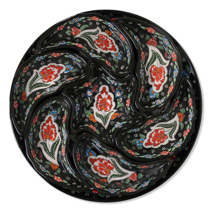 Set of ceramic snack serving trays  with floral patterns on a black background