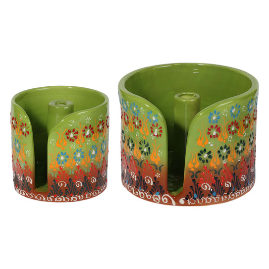 Two green ceramic paper towel holders with floral patterns on a white background