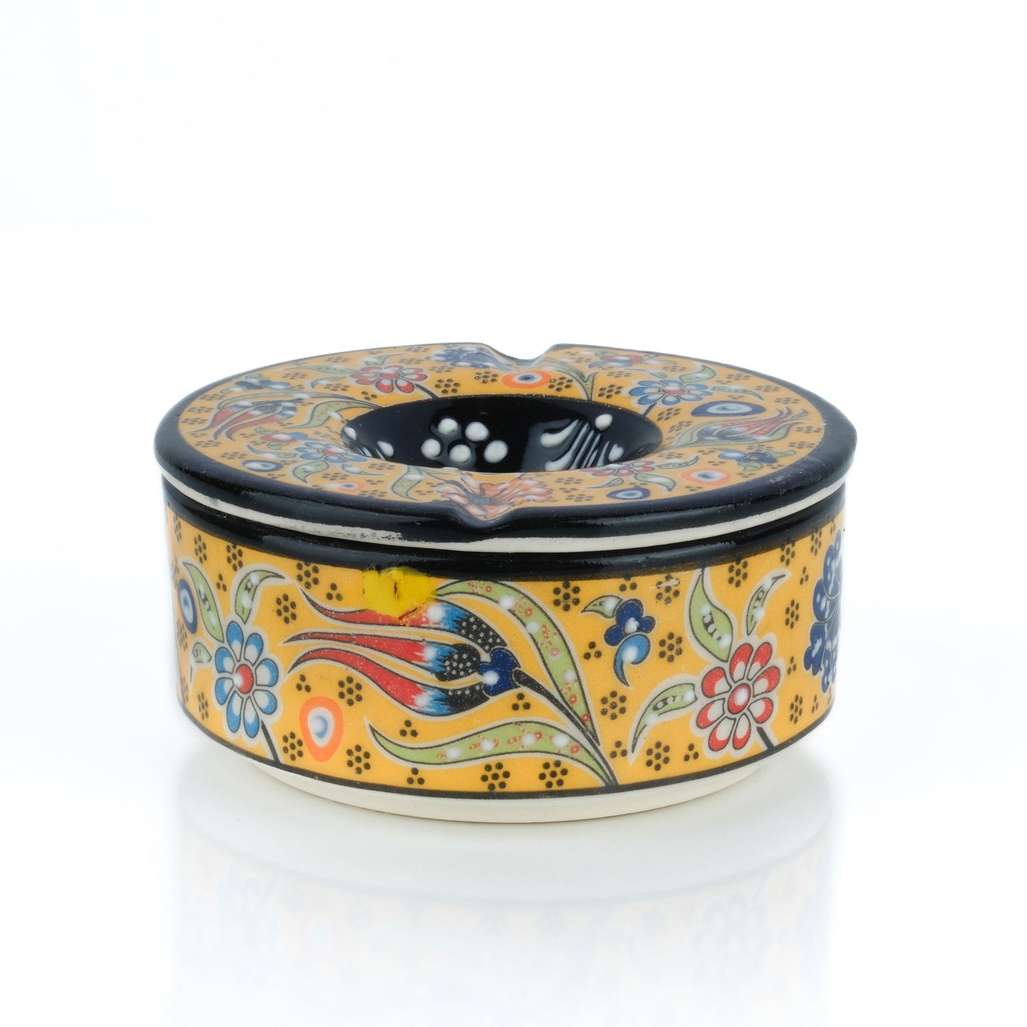 A handmade ceramic ashtray with a colorful floral pattern and a lid.