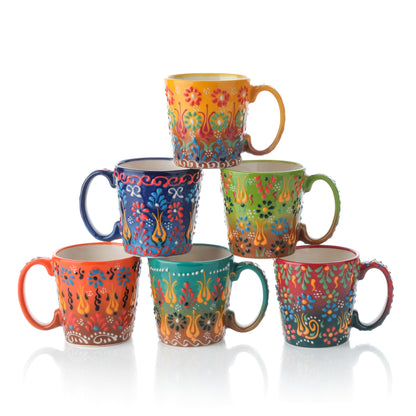 A set of six colorful handcrafted ceramic coffee mugs with a tapered design, displayed in a stacked arrangement.