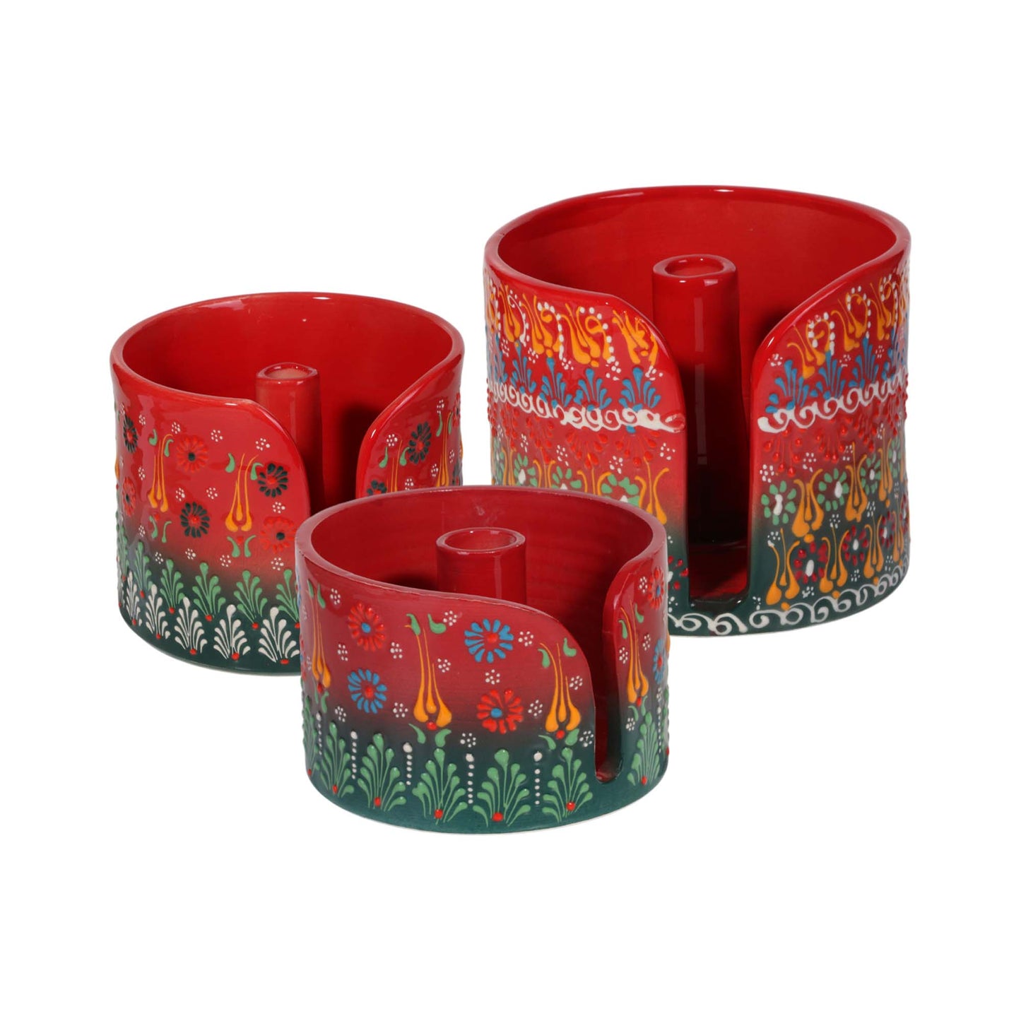 Three red cylindrical paper towel holders with colorful floral patterns on a white background