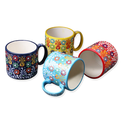 A set of four ceramic espresso cups in various colorful patterns.