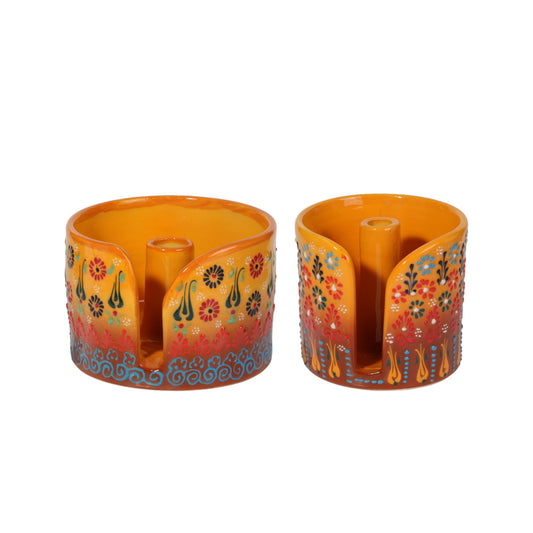 Two colorful ceramic paper towel holder with floral designs on a white background