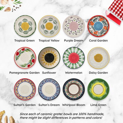 Collection of ceramic grater bowls with various patterns and colors on a marble surface.