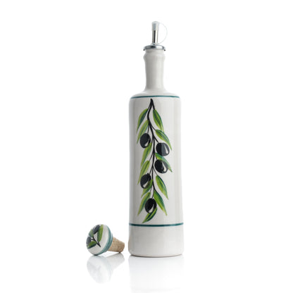 A ceramic oil dispenser with a white body and green leaf patterns, alongside a cork stopper and a silicone pouring spout.