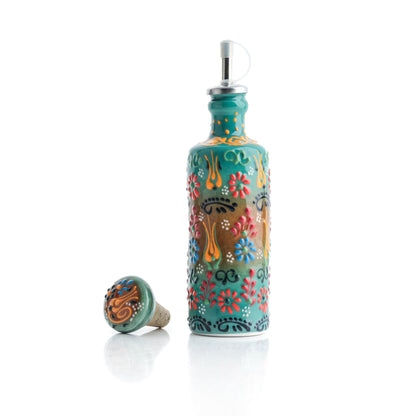 Decorative olive oil bottle with floral patterns on a white background