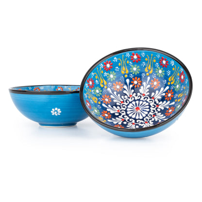 Two blue ceramic bowls with floral patterns on a white background