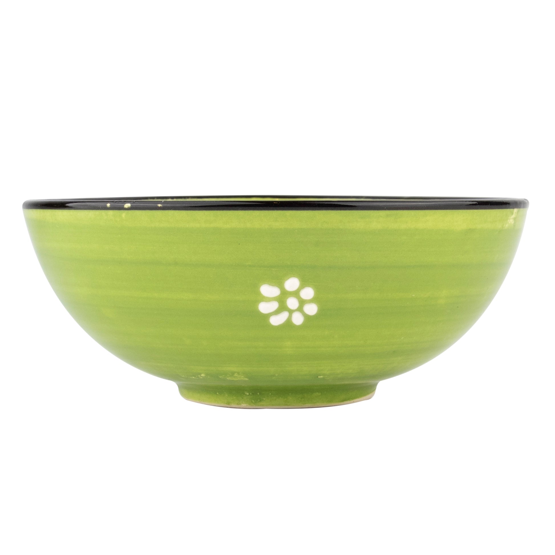 Green ceramic bowl with a white floral design on a white background