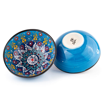 Decorative blue ceramic bowl with floral patterns on a white background