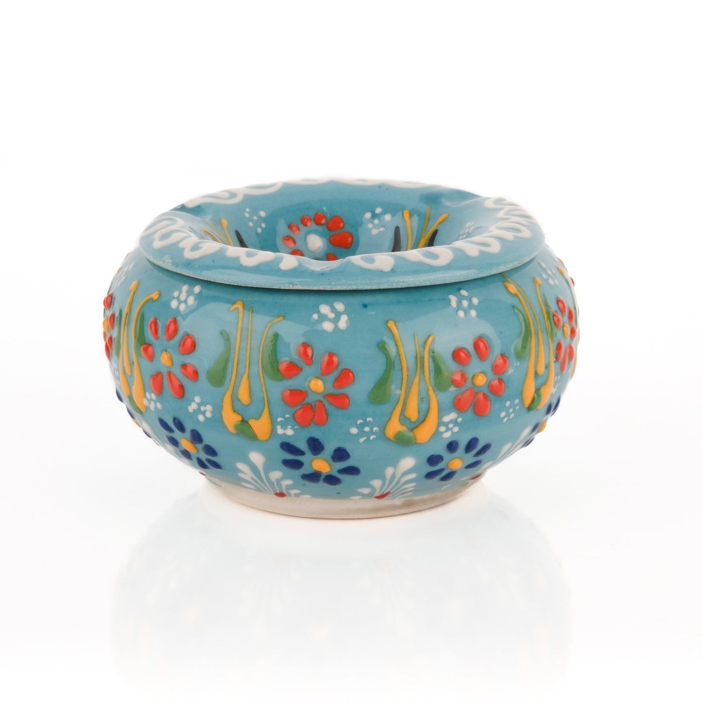 A handmade ceramic ashtray with a floral pattern in turquoise color, featuring a lid.