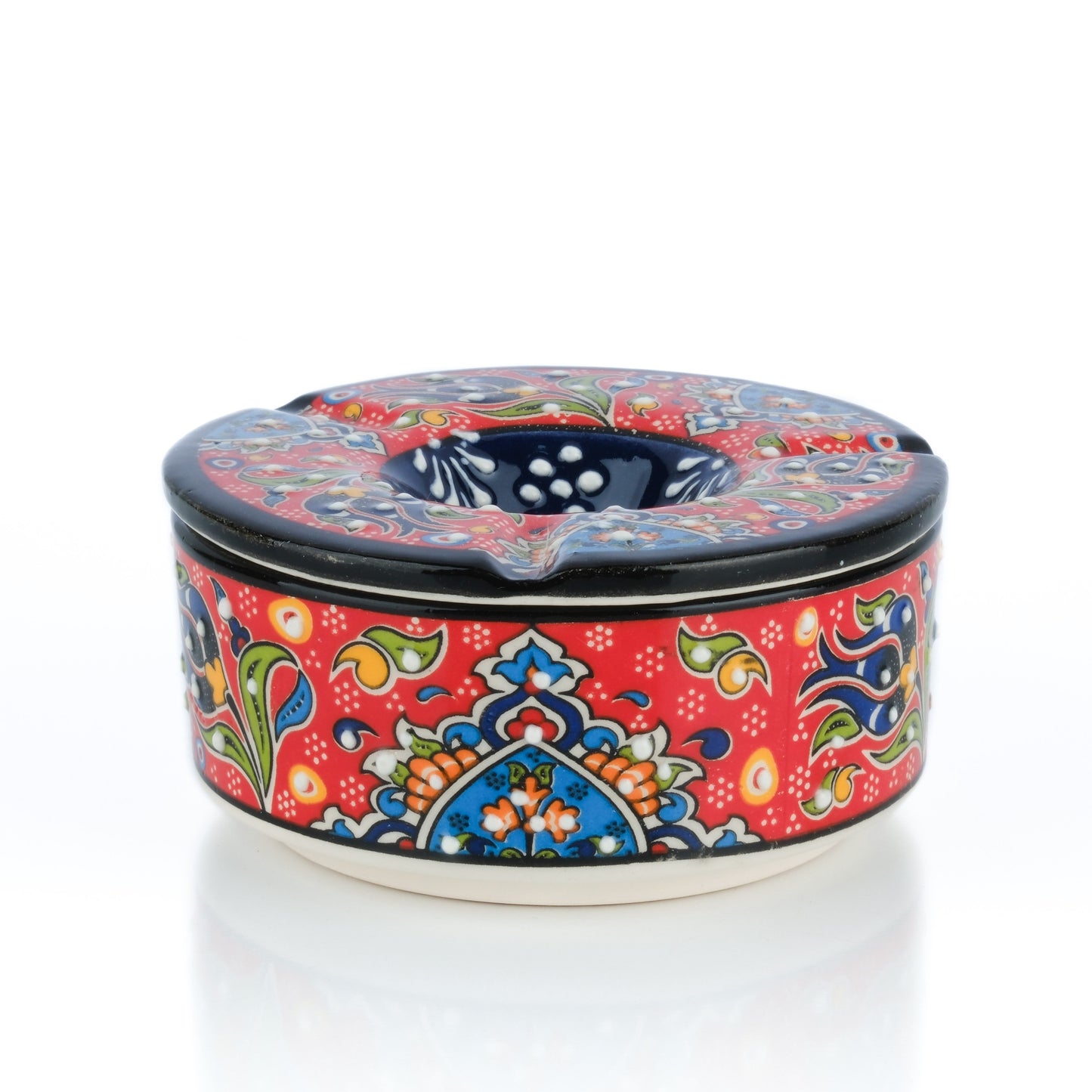 Colorful ceramic ashtray with intricate patterns on a white background