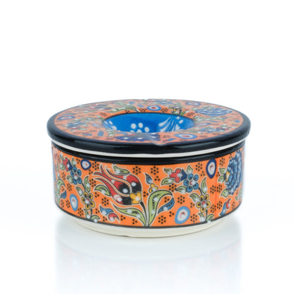 Decorative ceramic ashtray with floral patterns on a white background