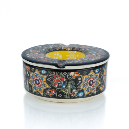 Decorative ceramic ashtray with colorful patterns on a white background