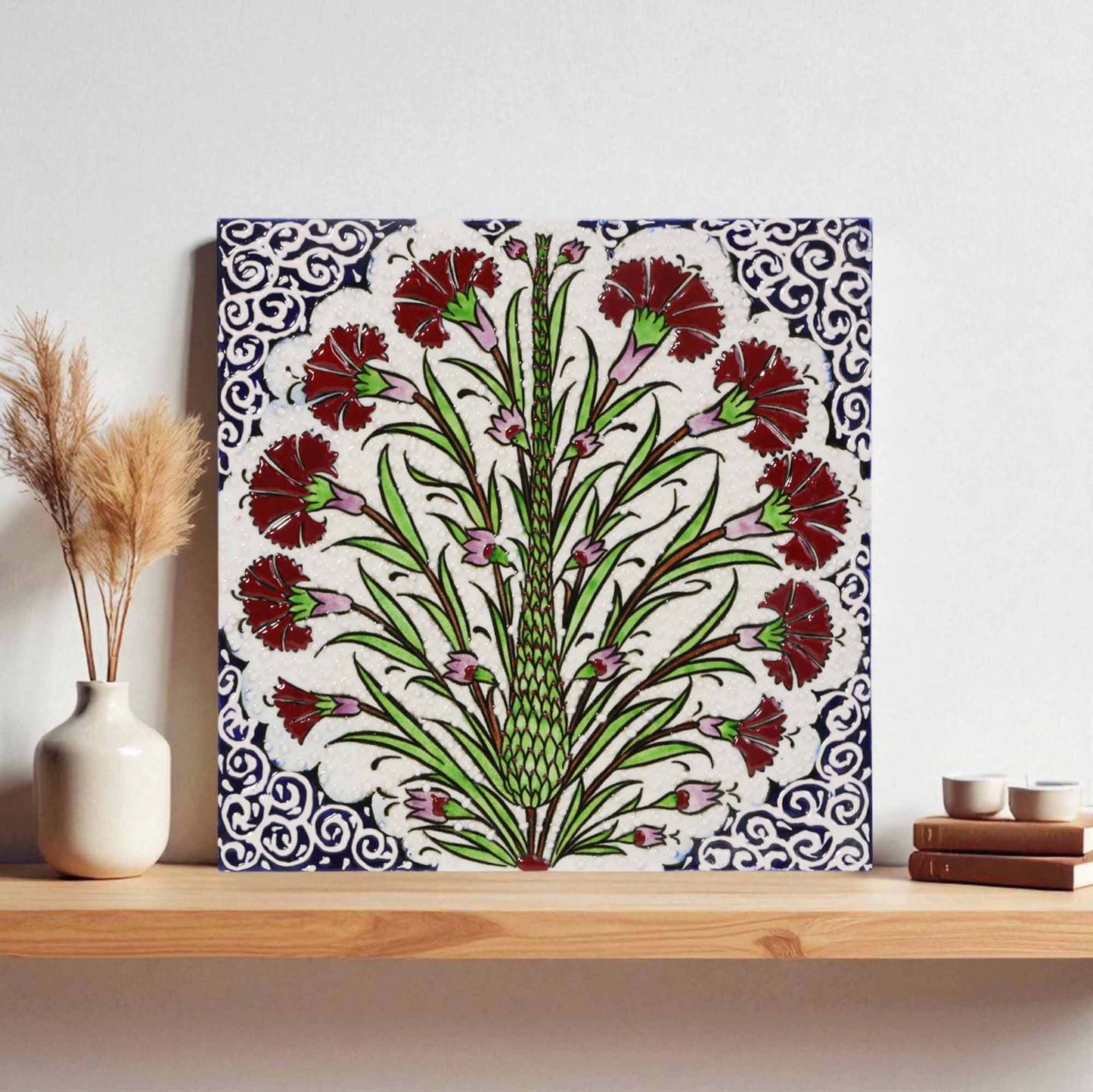 Decorative ceramic tile with floral design on a shelf