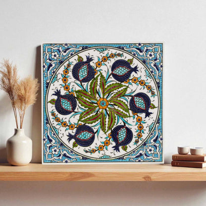 Decorative ceramic tile with floral and bird pattern on a wooden shelf