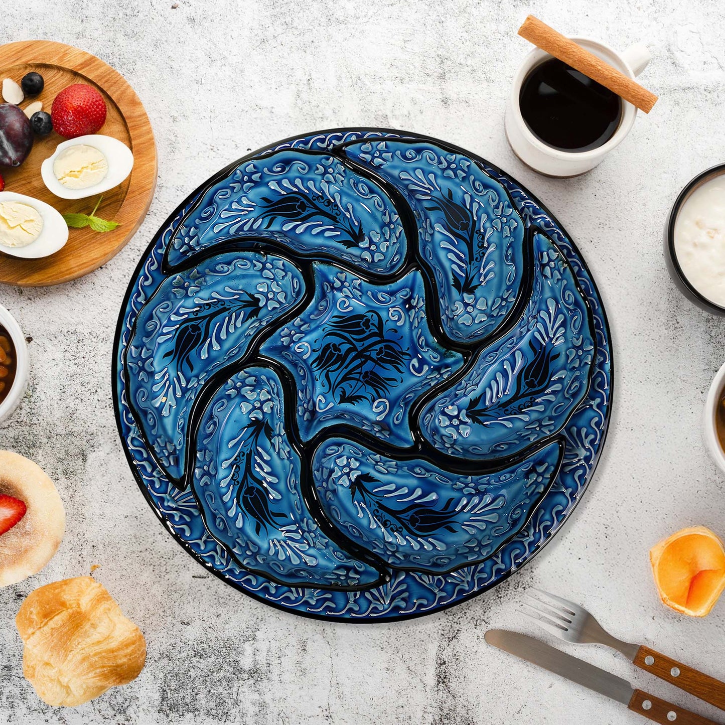 Blue decorative snack serving tray set with intricate design on a table with food items