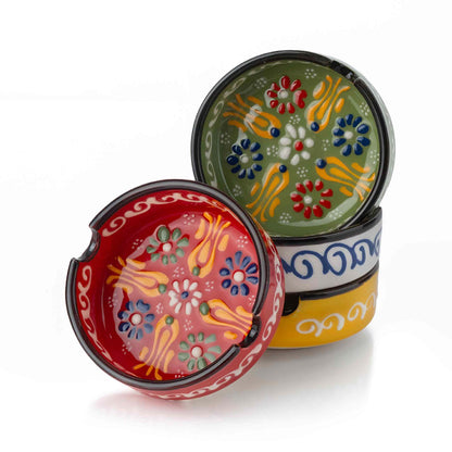 Three colorful ceramic ashtrays with floral designs on a white background