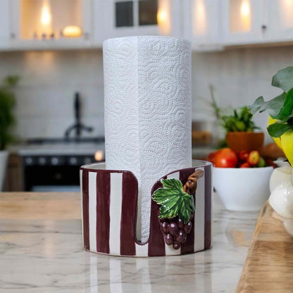 Decorative paper towel holder with grape design on a kitchen counter