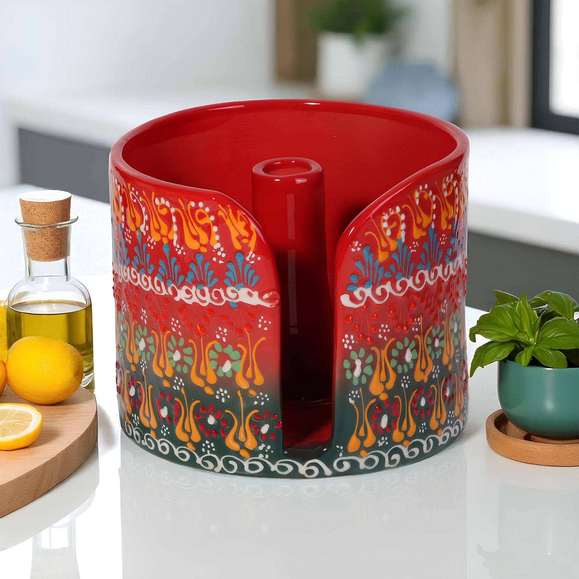 Decorative red paper towel holder with colorful patterns on a kitchen counter