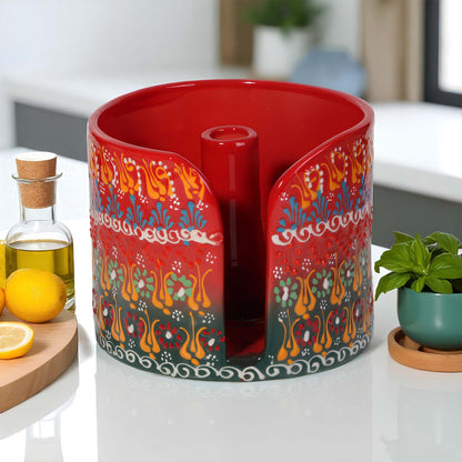 Decorative red paper towel holder with colorful patterns on a kitchen counter