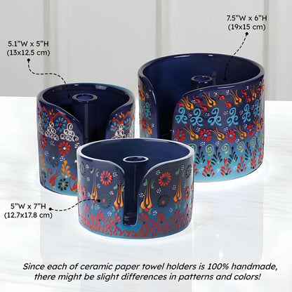Three ceramic paper towel holders with floral patterns on a white background