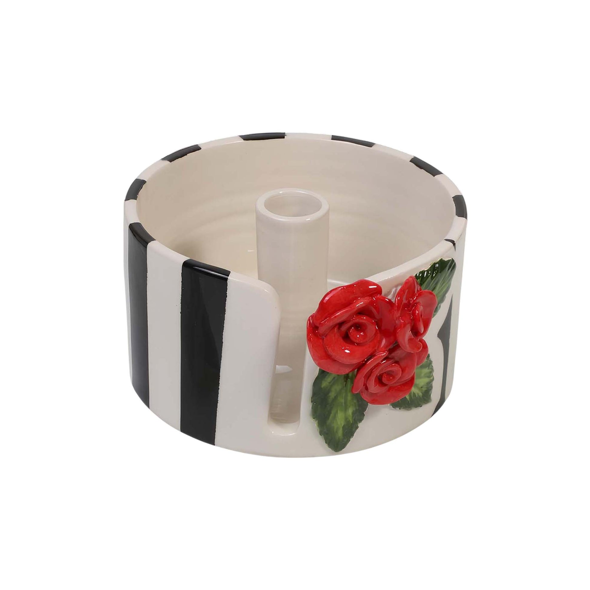 Ceramic paper towel holder with red roses and black and white design on a white background