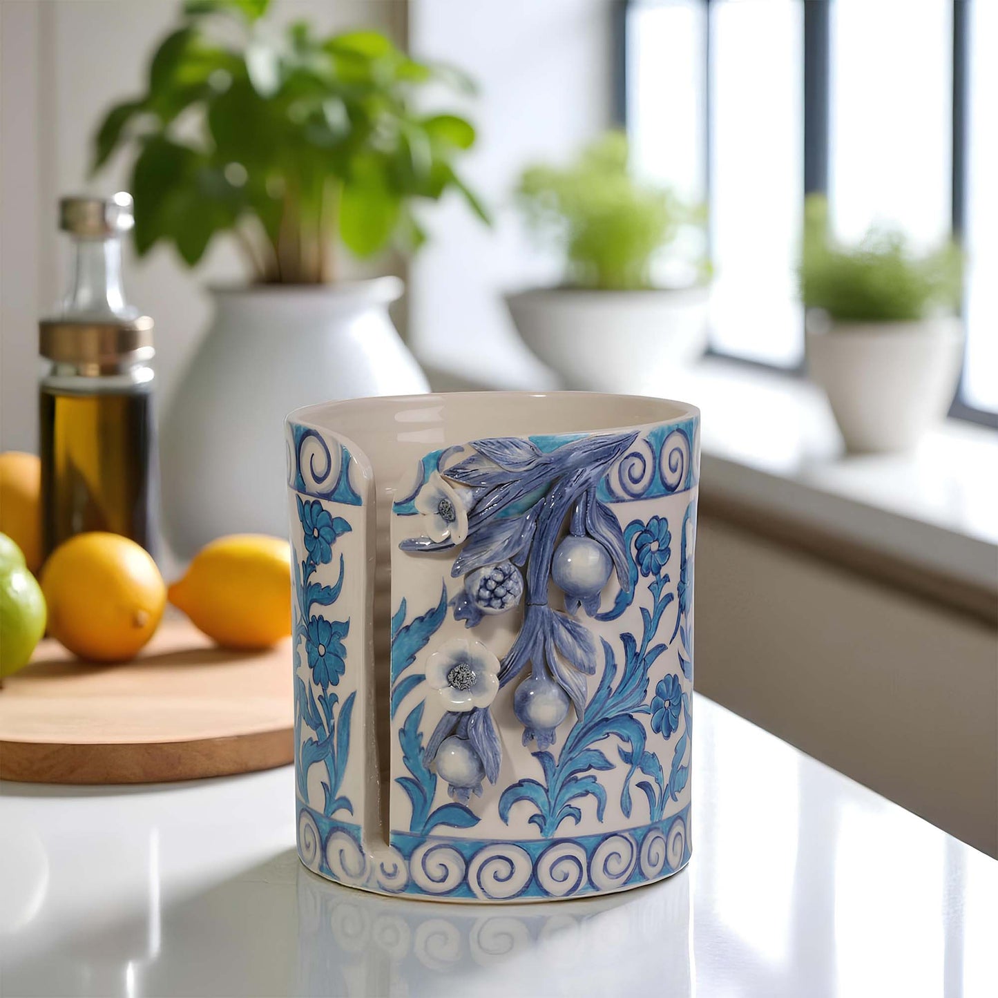 Decorative ceramic paper towel holder with blue floral patterns on a kitchen counter.