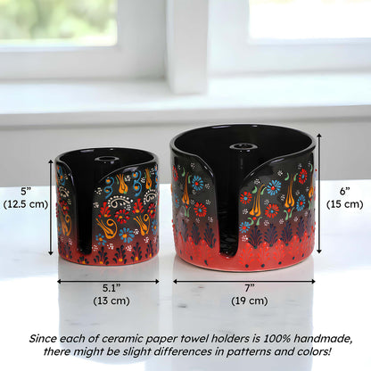 Two ceramic paper towel holders with floral designs and measurements on a white surface.