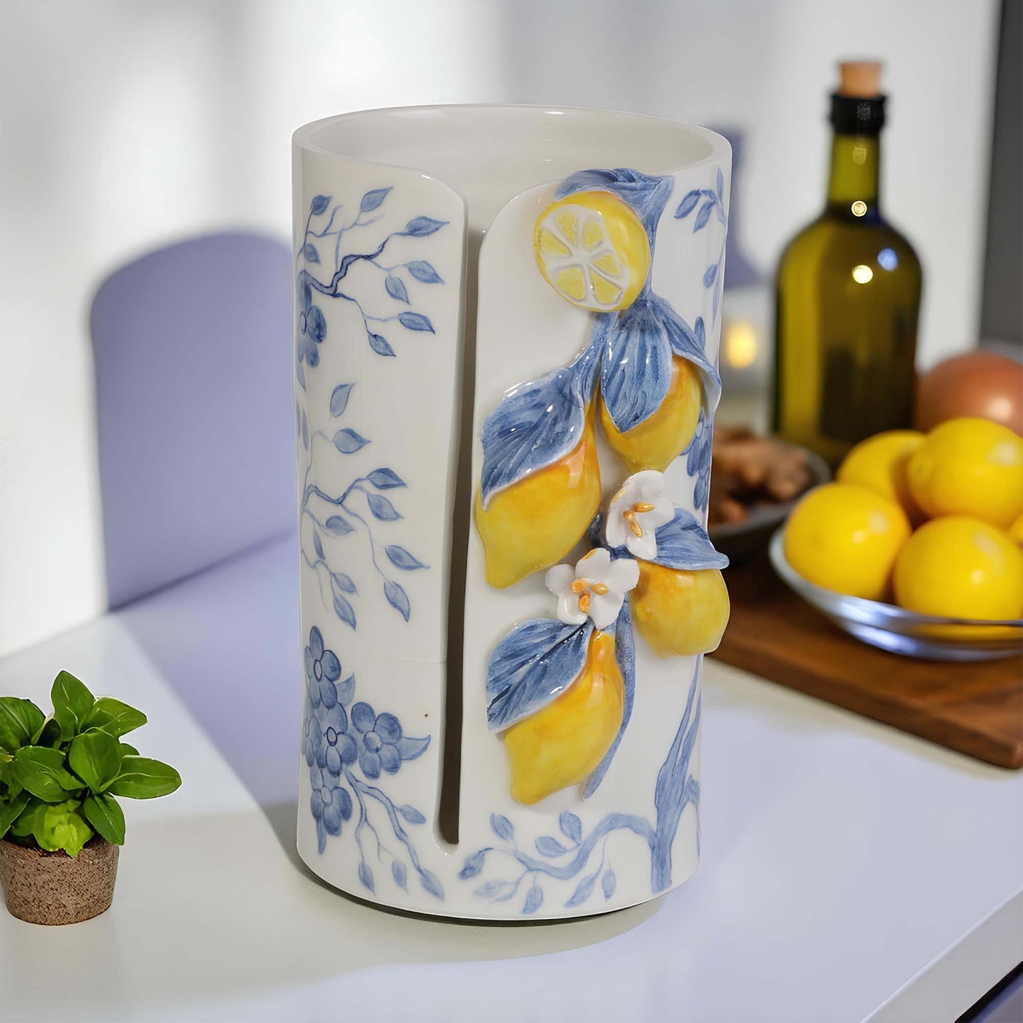 Ceramic paper towel holder with lemon and floral design on a kitchen counter