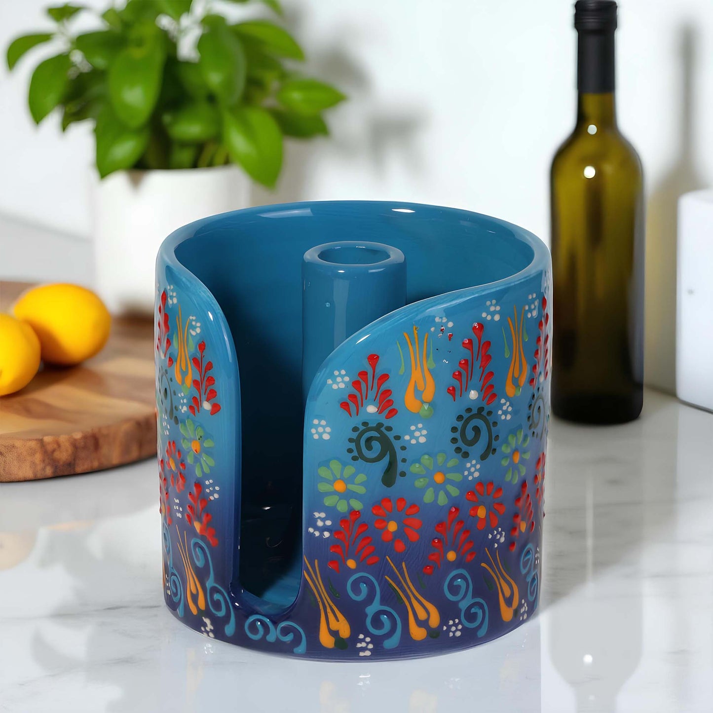 Blue ceramic paper towel holder with floral patterns on a kitchen counter