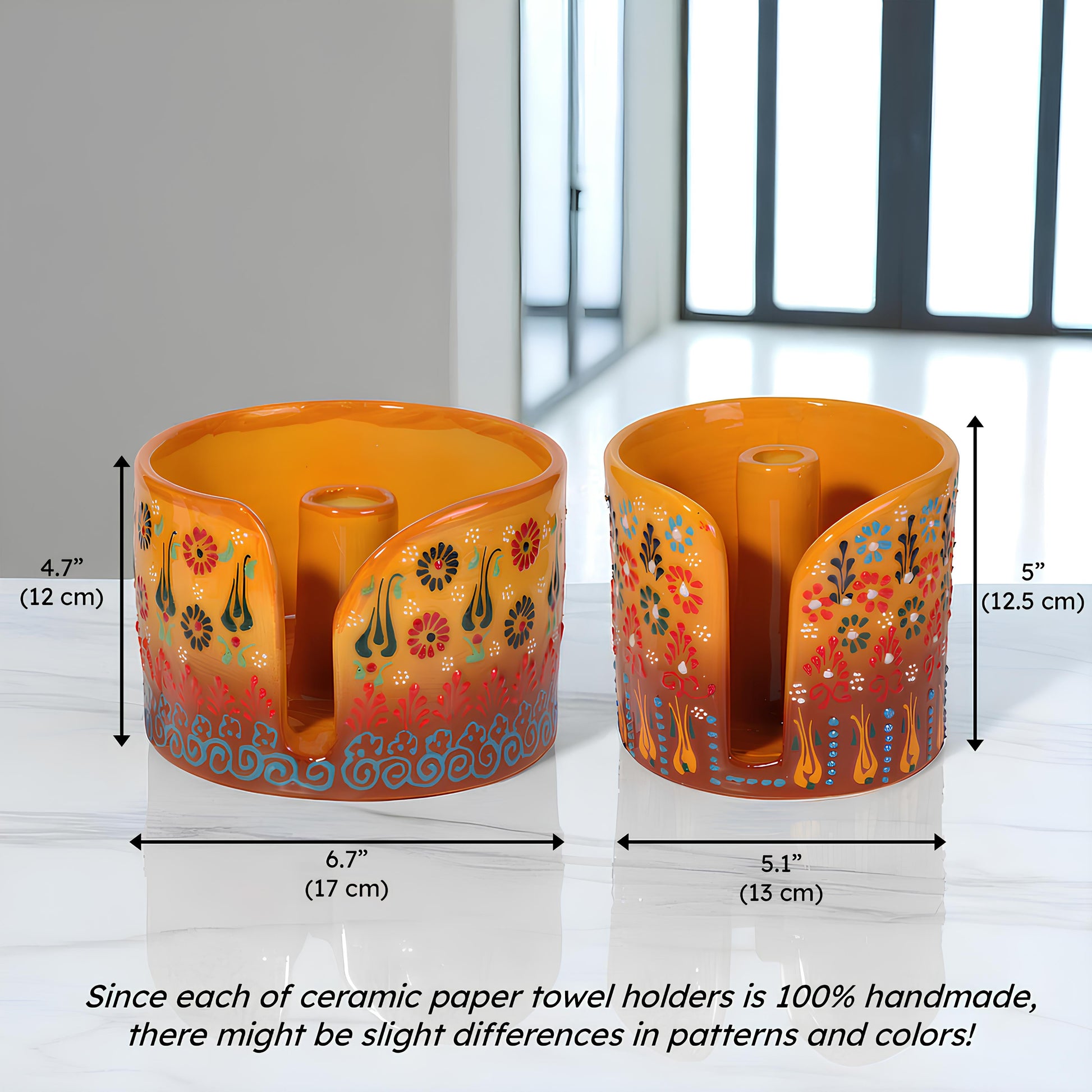 Two ceramic paper towel holders with floral designs and measurements on a white background.