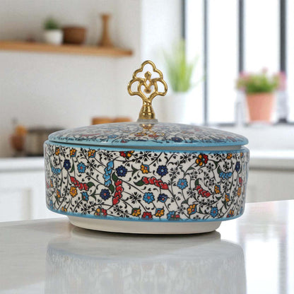 Decorative ceramic sugar bowl with floral patterns on a kitchen counter
