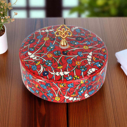 Decorative sugar bowl with floral pattern on a wooden surface