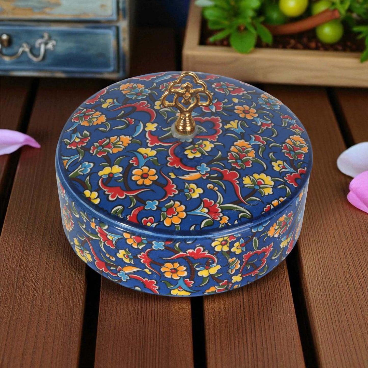 Decorative sugar bowl with floral patterns on a wooden surface