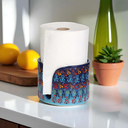 Decorative paper towel holder with a floral design on a kitchen counter.