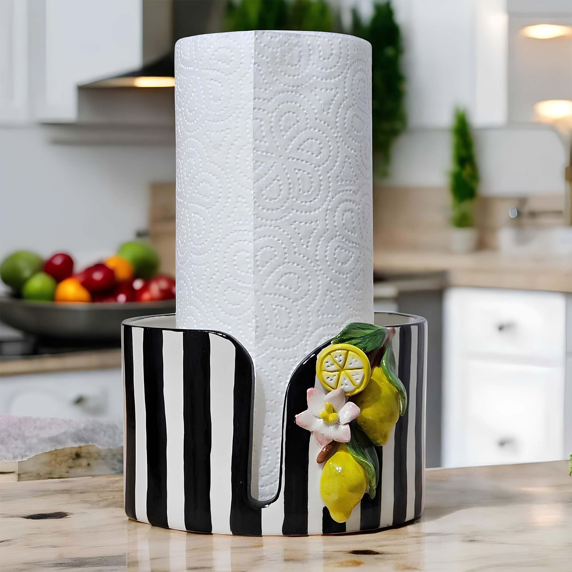 Decorative paper towel holder with black and white stripes and lemon design on a kitchen counter.