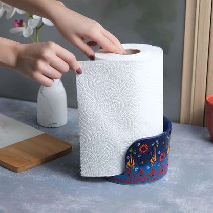 Person reaching for a roll of paper towels in a decorative paper towel holder on a kitchen counter.