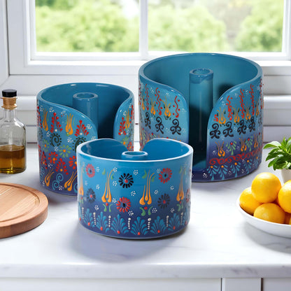 Set of blue paper towel holder with colorful designs on a kitchen counter.