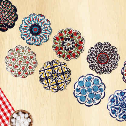 Colorful floral and geometric coasters on a wooden surface with a checkered cloth and bowl of marshmallows.