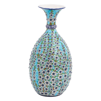 A hand-painted ceramic decorative bottle with a turquoise background and white floral patterns.