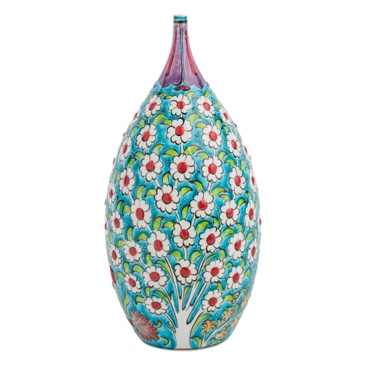 A hand-painted ceramic decorative bottle with a vibrant floral pattern in white, red, and green on a turquoise background, featuring a pointed top.