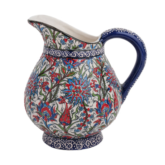 A hand-painted ceramic pitcher with a traditional floral design, featuring tulips and carnations in red, blue, and green colors on a white background.