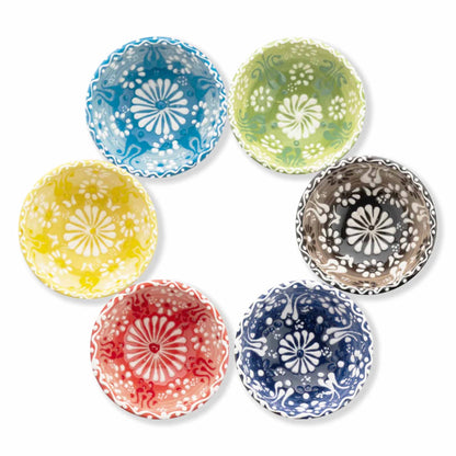 Set of six colorful ceramic dip bowls with floral patterns on a white background