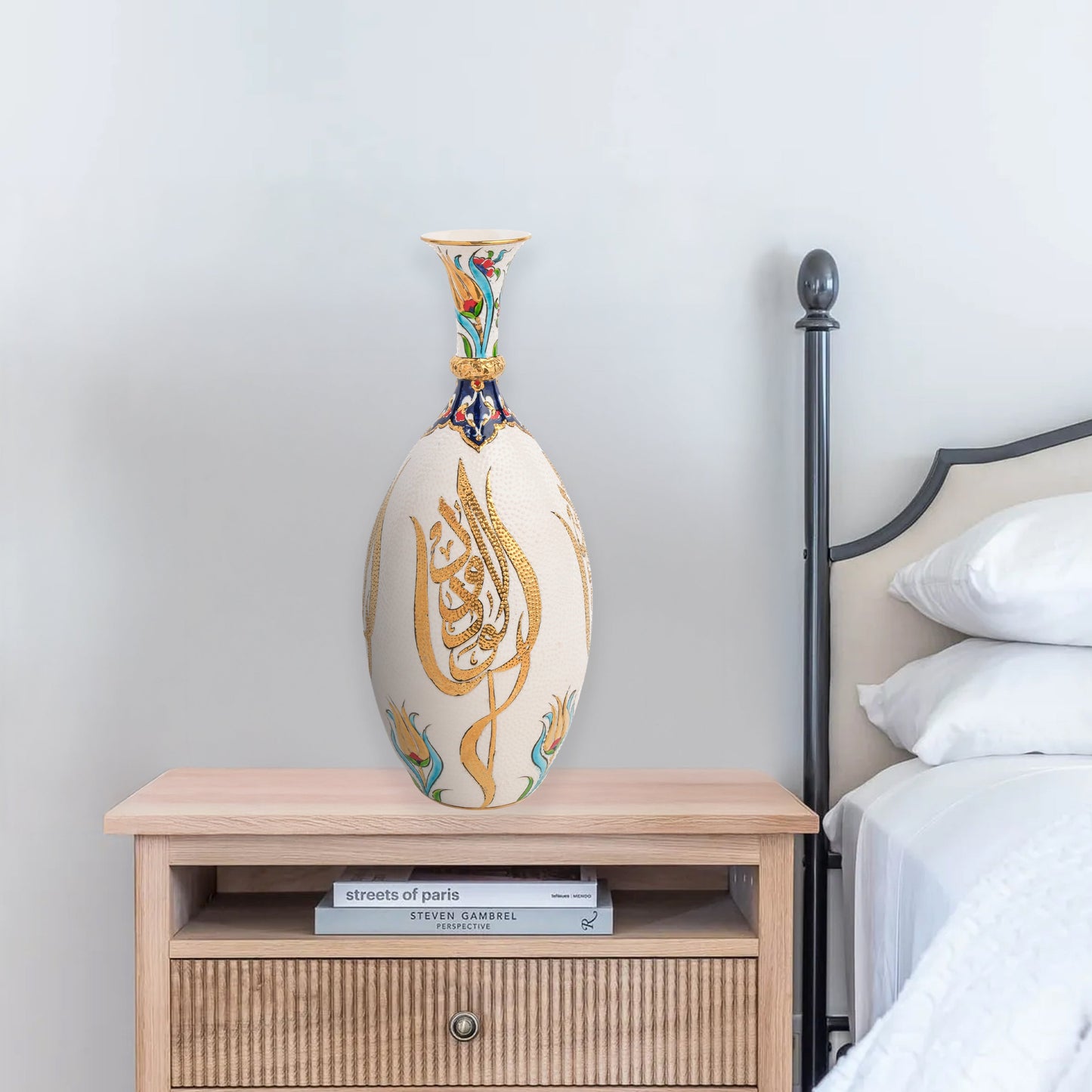 Hand-painted ceramic decorative bottle with golden Arabic calligraphy on ivory, accented with floral motifs. Glossy artisan vase, perfect for décor or gifts.