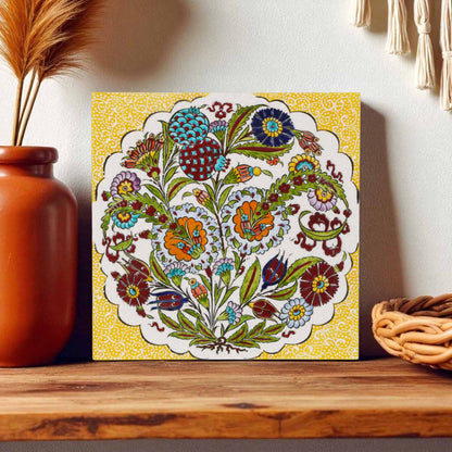 Decorative ceramic tile with floral pattern on a wooden shelf